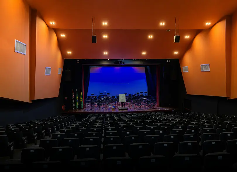 Interior do Teatro Municipal de Bauru com palco e poltronas
